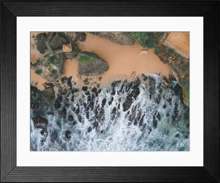 Framed Print : Top down aerial view of giant ocean waves crashing and foaming in coral beach Framed Print : Top down aerial view of giant ocean waves crashing and foaming in coral beach