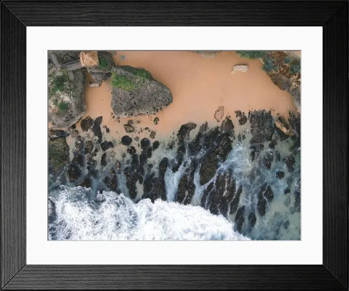 Framed Print : Top down aerial view of giant ocean waves crashing and foaming in coral beach Framed Print : Top down aerial view of giant ocean waves crashing and foaming in coral beach