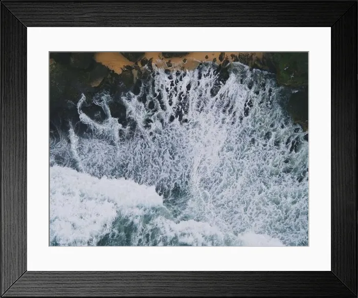 Framed Print : Top down aerial view of giant ocean waves crashing and foaming in coral beach Framed Print : Top down aerial view of giant ocean waves crashing and foaming in coral beach