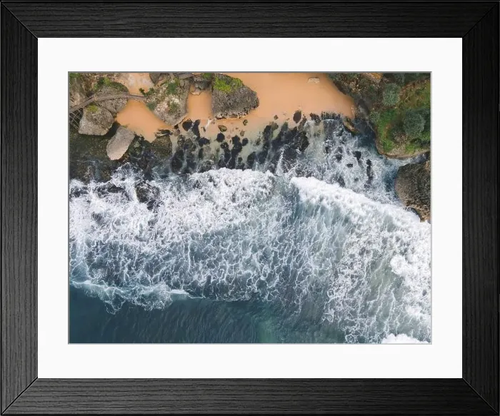 Framed Print : Top down aerial view of giant ocean waves crashing and foaming in coral beach Framed Print : Top down aerial view of giant ocean waves crashing and foaming in coral beach