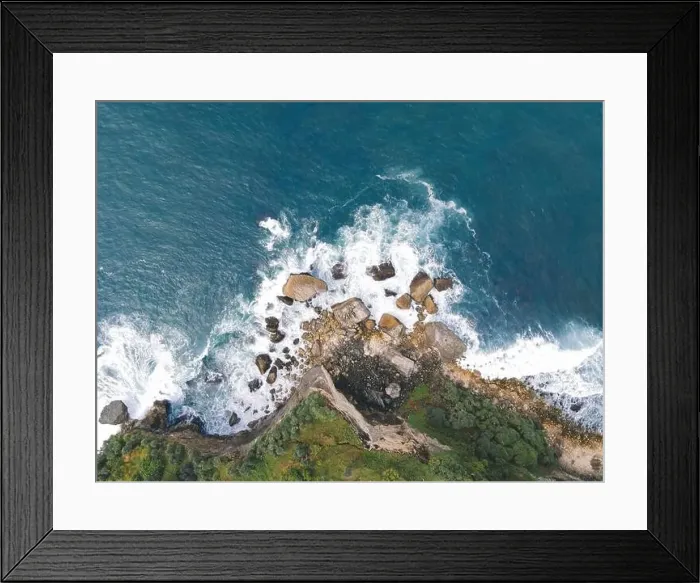 Framed Print : Top down aerial view of giant ocean waves crashing and foaming in coral beach