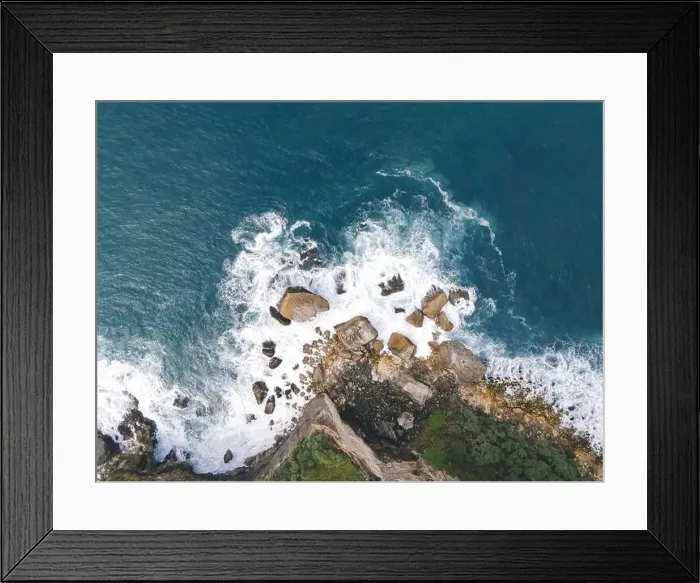 Framed Print : Top down aerial view of giant ocean waves crashing and foaming in coral beach Framed Print : Top down aerial view of giant ocean waves crashing and foaming in coral beach