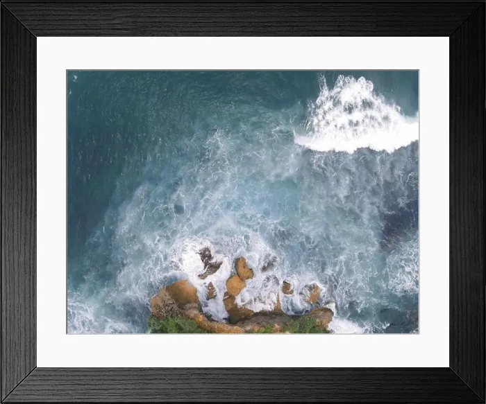 Framed Print : Top down aerial view of giant ocean waves crashing and foaming in coral beach Framed Print : Top down aerial view of giant ocean waves crashing and foaming in coral beach