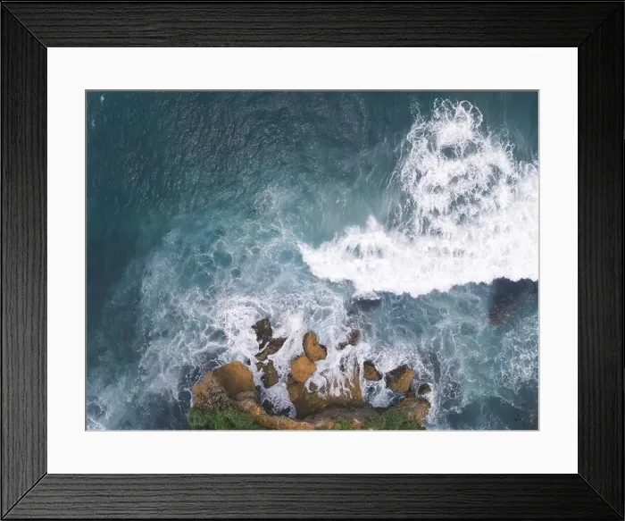 Framed Print : Top down aerial view of giant ocean waves crashing and foaming in coral beach