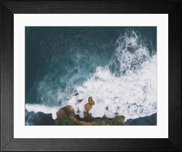 Framed Print : Top down aerial view of giant ocean waves crashing and foaming in coral beach Framed Print : Top down aerial view of giant ocean waves crashing and foaming in coral beach