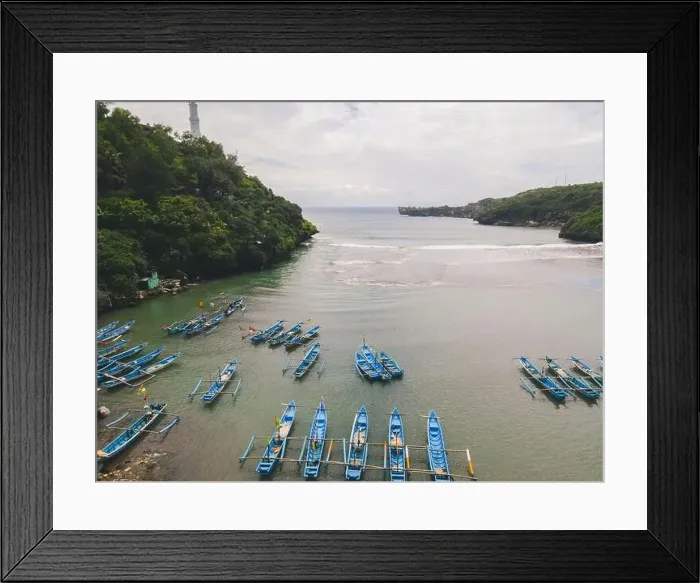 Framed Print : Aerial view of Baron beach in Yogyakarta, Indonesia with lighthouse and traditional boats Framed Print : Aerial view of Baron beach in Yogyakarta, Indonesia with lighthouse and traditional boats