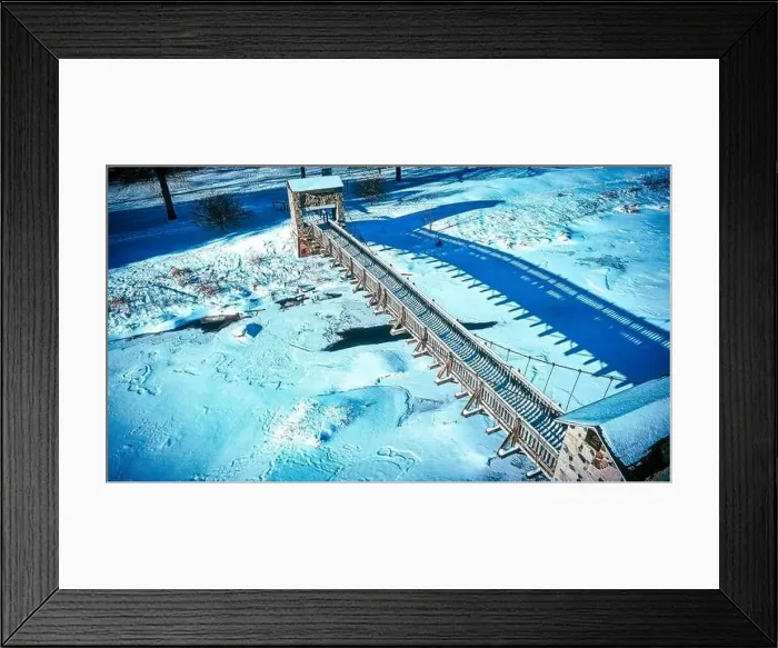Framed Print : Aerial of frozen park walking bridge Framed Print : Aerial of frozen park walking bridge