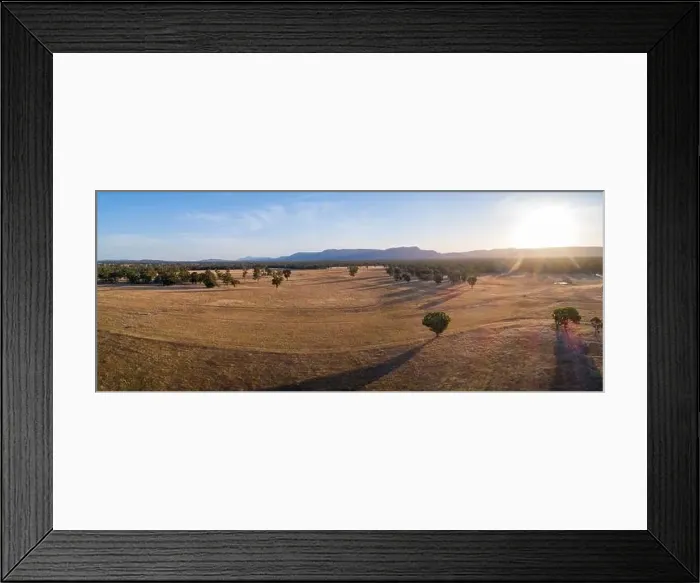 Framed Print : Agricultural land with mountains in the background at sunset - aerial panoramic landscape Framed Print : Agricultural land with mountains in the background at sunset - aerial panoramic landscape