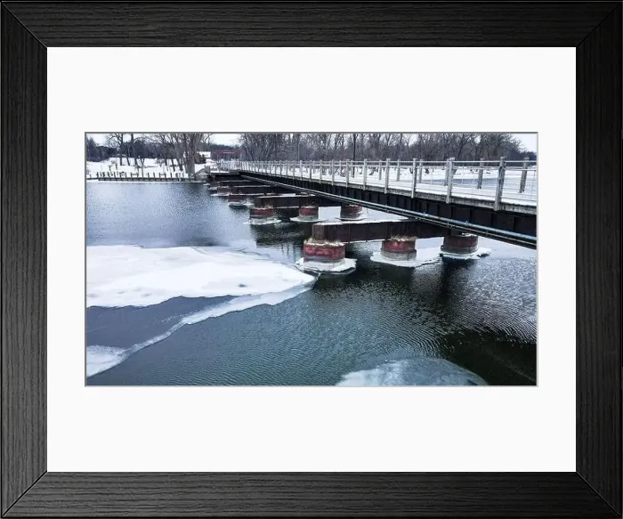 Framed Print : The frozen landscape with hiking / walking trail bridge over the frozen water Framed Print : The frozen landscape with hiking / walking trail bridge over the frozen water