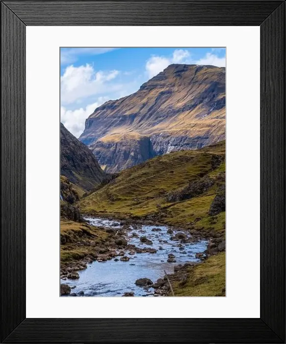 Framed Print : A rocky scenic river in Saksun, Faroe Islands with a steep mountain on the background Framed Print : A rocky scenic river in Saksun, Faroe Islands with a steep mountain on the background