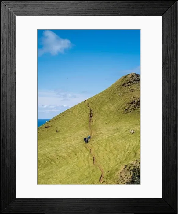Framed Print : The lime green grass and brilliant blue sky steal the show as these three hikers face a steep incline Framed Print : The lime green grass and brilliant blue sky steal the show as these three hikers face a steep incline