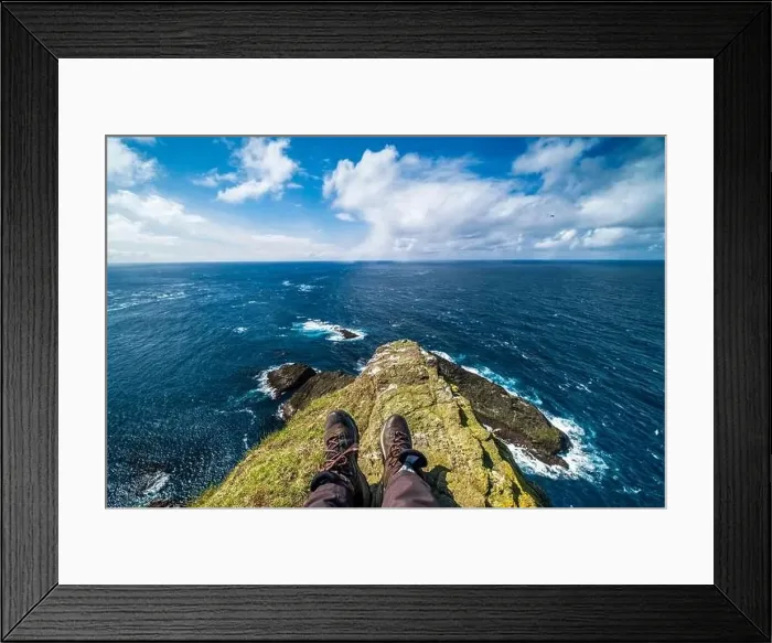 Framed Print : A hiker stretches her legs on a bright green outcrop of rock Framed Print : A hiker stretches her legs on a bright green outcrop of rock