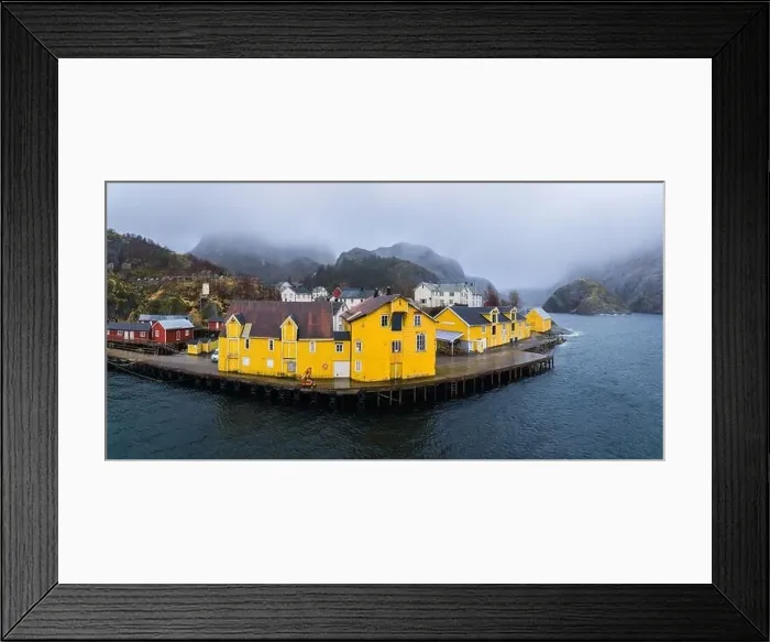 Framed Print : Scenic drone view of small settlement with typical colorful residential houses at seaside surrounded by huge rocky Framed Print : Scenic drone view of small settlement with typical colorful residential houses at seaside surrounded by huge rocky