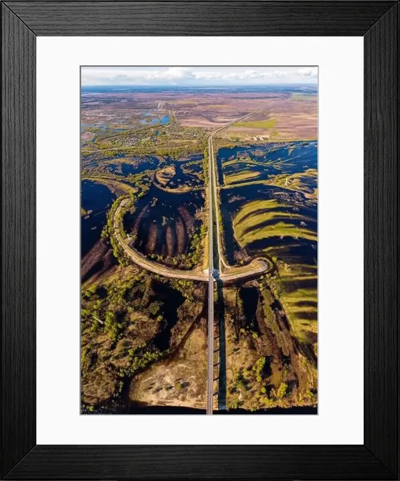 Framed Print : Road across flooded floodplains meadows from above. Pripyat river delta flooded with water in spring Framed Print : Road across flooded floodplains meadows from above. Pripyat river delta flooded with water in spring