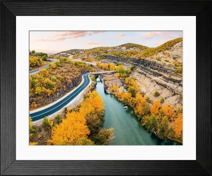 Framed Print : Aerial drone view of a road passing a narrow gorge of a river by bridge during golden autumn in Greece Framed Print : Aerial drone view of a road passing a narrow gorge of a river by bridge during golden autumn in Greece