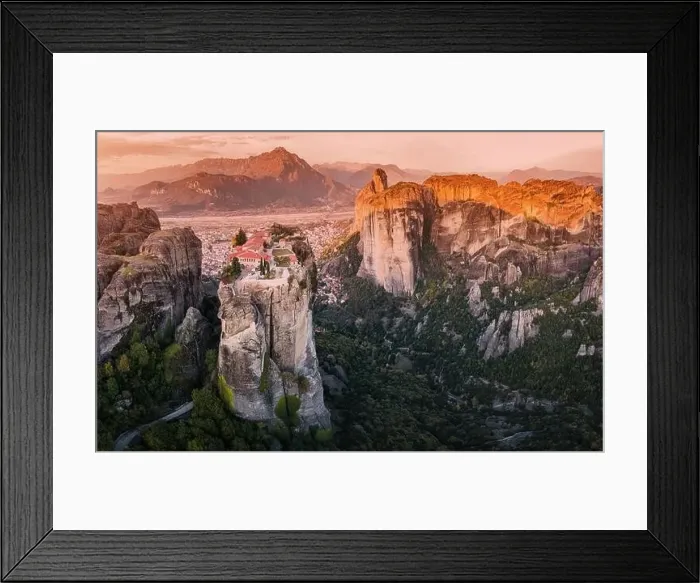 Framed Print : Scenic panoramic view of the Monastery of the Holy Trinity in Meteora at sunrise and Kalambaka town at the distance Framed Print : Scenic panoramic view of the Monastery of the Holy Trinity in Meteora at sunrise and Kalambaka town at the distance
