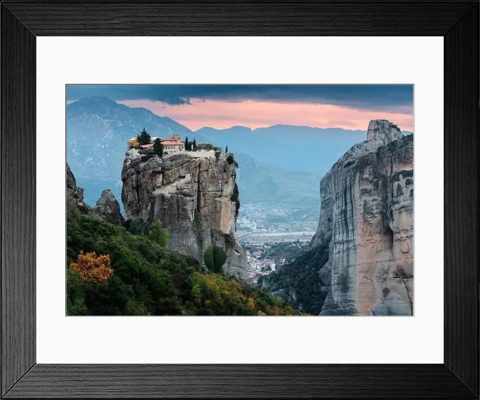 Framed Print : Scenic twilight view of the Monastery of the Holy Trinity in Meteora at sunset and Kalambaka town at the distance Framed Print : Scenic twilight view of the Monastery of the Holy Trinity in Meteora at sunset and Kalambaka town at the distance