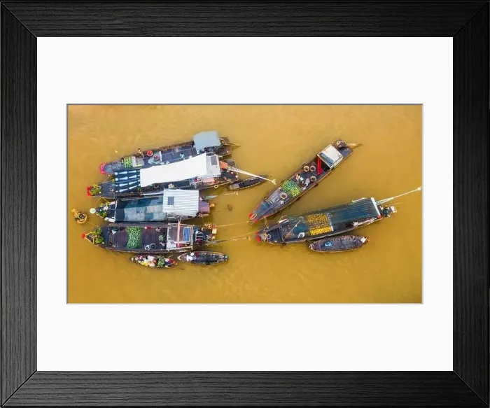 Framed Print : Cai Rang floating market is bustling with Tet boats to welcome the new year Framed Print : Cai Rang floating market is bustling with Tet boats to welcome the new year