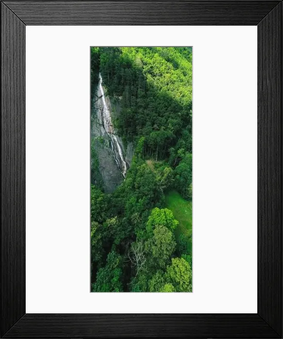 Framed Print : Vertical panorama. Waterfall in the mountains near the village of Brunnen. Forest in the Alps Switzerland Framed Print : Vertical panorama. Waterfall in the mountains near the village of Brunnen. Forest in the Alps Switzerland