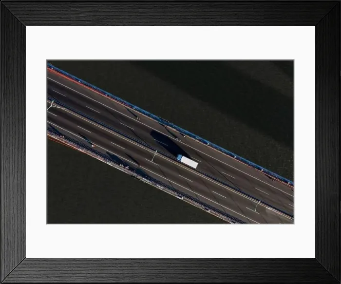 Framed Print : Top ascending aerial view of cable- stayed Can Tho bridge road with driving cars Framed Print : Top ascending aerial view of cable- stayed Can Tho bridge road with driving cars