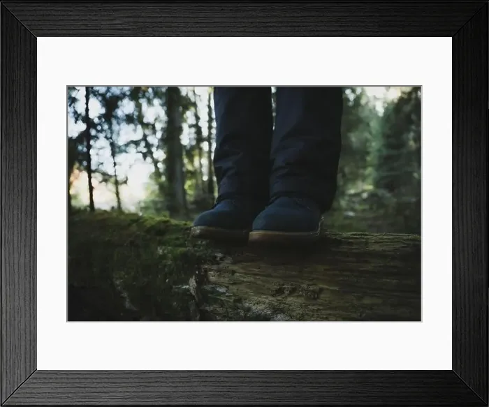 Framed Print : Woman in boots standing on log in forest Framed Print : Woman in boots standing on log in forest