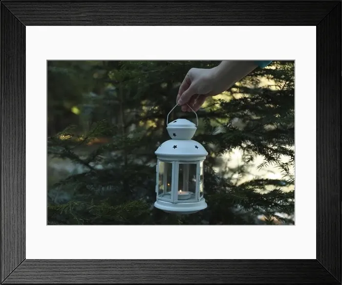 Framed Print : Female hand holds lantern with candle in forest Framed Print : Female hand holds lantern with candle in forest