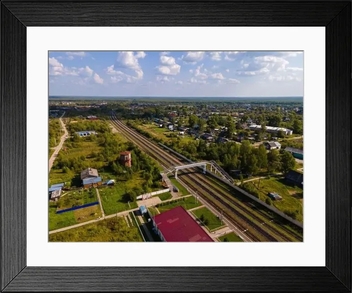 Framed Print : Railroad between trees and houses under cloudy blue sky Framed Print : Railroad between trees and houses under cloudy blue sky