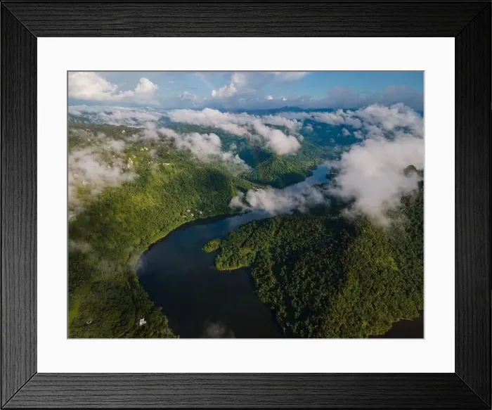 Framed Print : Drone view of calm winding lake streaming through hilly valley covered with dense forest and clouds Framed Print : Drone view of calm winding lake streaming through hilly valley covered with dense forest and clouds