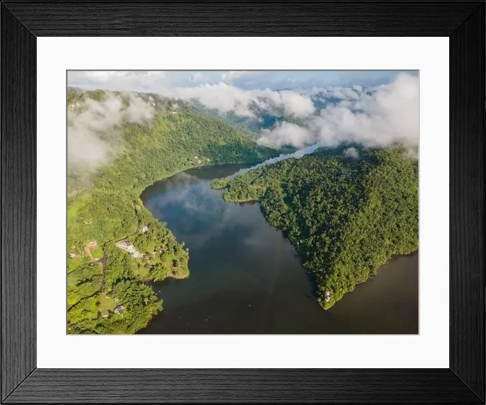 Framed Print : Drone view of calm winding lake streaming through hilly valley covered with dense forest and clouds Framed Print : Drone view of calm winding lake streaming through hilly valley covered with dense forest and clouds