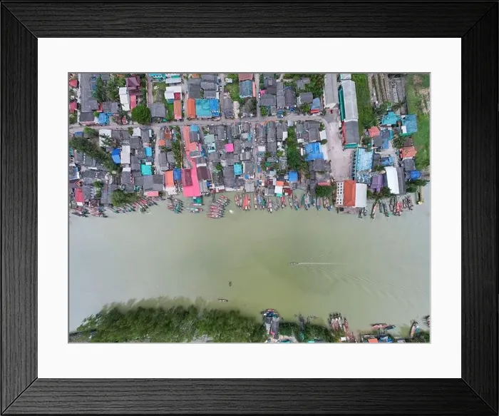 Framed Print : Aerial view top view of the fisherman village with fishing boats and house roof at the pier in suratthani Thailand Framed Print : Aerial view top view of the fisherman village with fishing boats and house roof at the pier in suratthani Thailand
