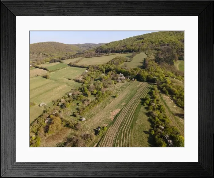Framed Print : Drone flight over green meadows, forests, landscape, nature in April in Austria Framed Print : Drone flight over green meadows, forests, landscape, nature in April in Austria