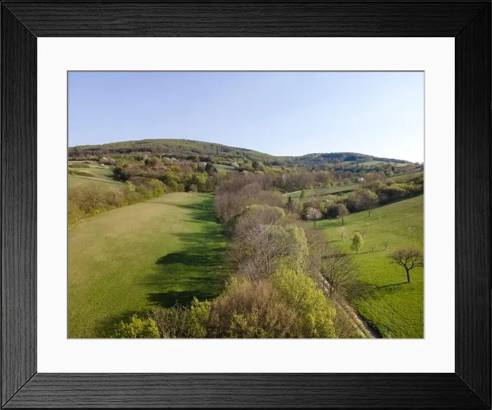 Framed Print : Drone flight over green meadows, forests, landscape, nature in April in Austria Framed Print : Drone flight over green meadows, forests, landscape, nature in April in Austria