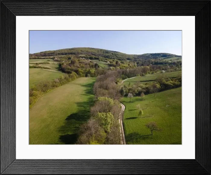Framed Print : Drone flight over green meadows, forests, landscape, nature in April in Austria Framed Print : Drone flight over green meadows, forests, landscape, nature in April in Austria