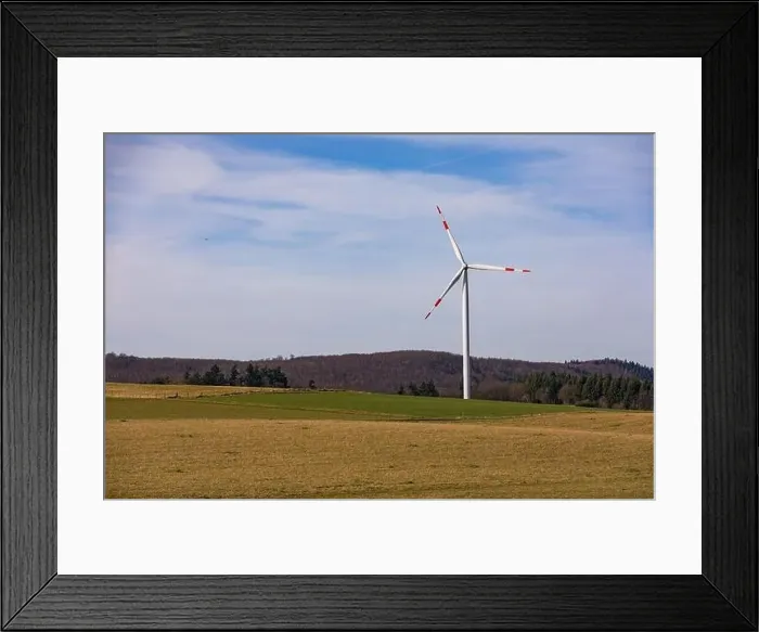Framed Print : Aerial view of a wind turbine with red and white rotor blades in a rural landscape Framed Print : Aerial view of a wind turbine with red and white rotor blades in a rural landscape