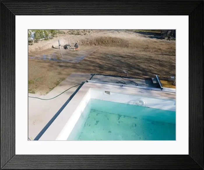 Framed Print : Drone flight over fresh earth area with grass grown next to pool construction site in April Framed Print : Drone flight over fresh earth area with grass grown next to pool construction site in April