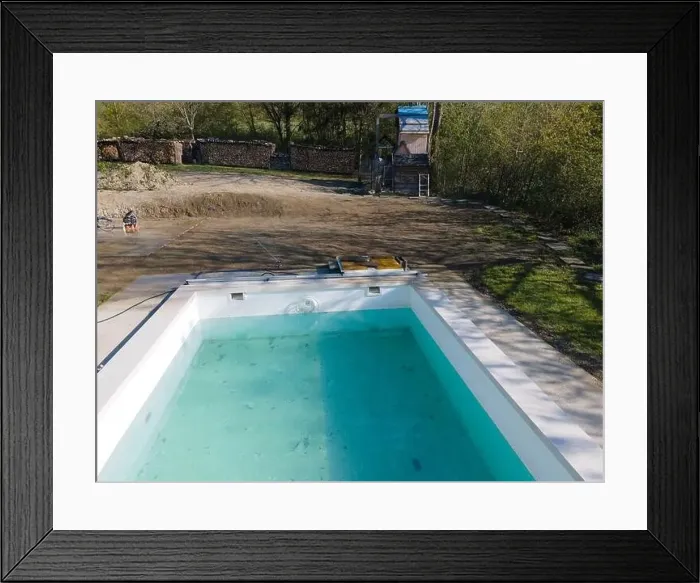 Framed Print : Drone flight over fresh earth area with grass grown next to pool construction site in April Framed Print : Drone flight over fresh earth area with grass grown next to pool construction site in April