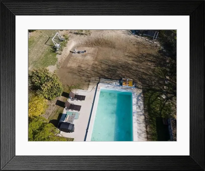 Framed Print : Drone flight over fresh earth area with grass grown next to pool construction site in April Framed Print : Drone flight over fresh earth area with grass grown next to pool construction site in April
