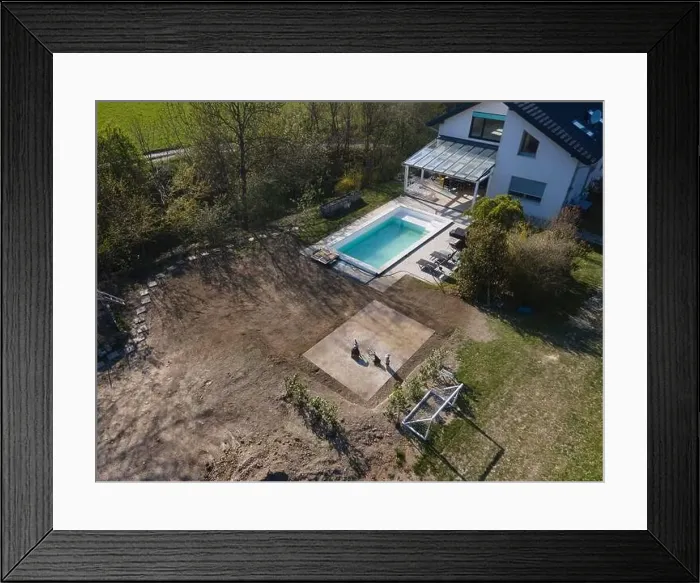Framed Print : Drone flight over fresh earth area with grass grown next to pool construction site in April Framed Print : Drone flight over fresh earth area with grass grown next to pool construction site in April