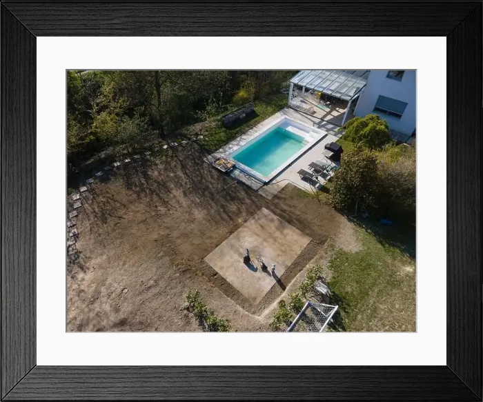 Framed Print : Drone flight over fresh earth area with grass grown next to pool construction site in April Framed Print : Drone flight over fresh earth area with grass grown next to pool construction site in April