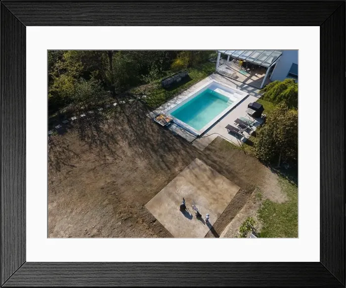 Framed Print : Drone flight over fresh earth area with grass grown next to pool construction site in April Framed Print : Drone flight over fresh earth area with grass grown next to pool construction site in April
