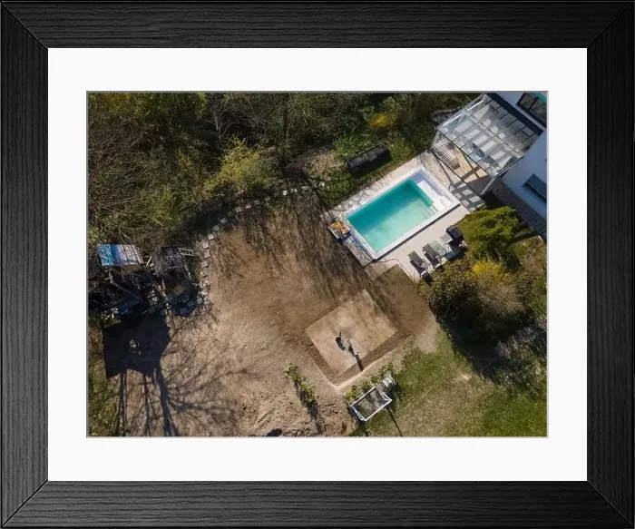 Framed Print : Drone flight over fresh earth area with grass grown next to pool construction site in April Framed Print : Drone flight over fresh earth area with grass grown next to pool construction site in April