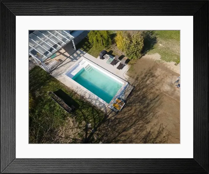Framed Print : Drone flight over fresh earth area with grass grown next to pool construction site in April Framed Print : Drone flight over fresh earth area with grass grown next to pool construction site in April