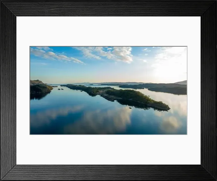 Framed Print : The water is like a mirror, the blue sky with small clouds is reflected in it Framed Print : The water is like a mirror, the blue sky with small clouds is reflected in it