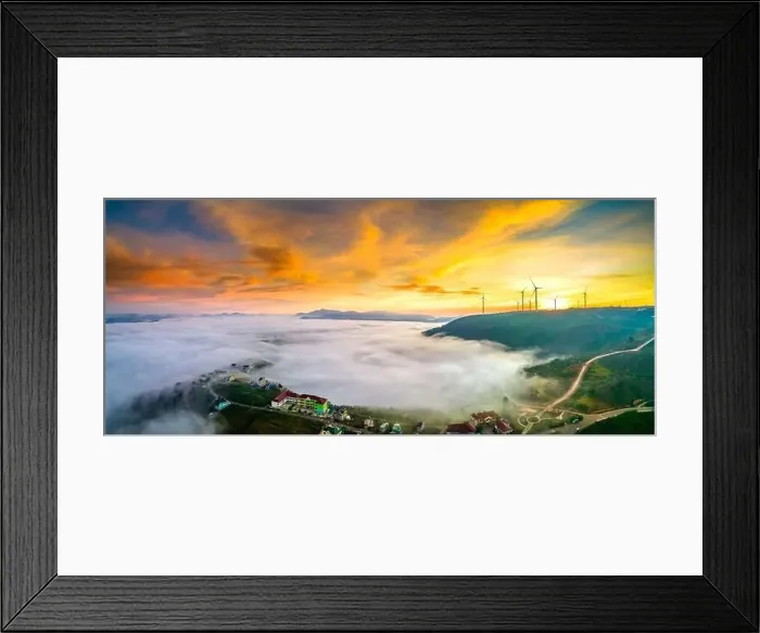 Framed Print : Aerial view top hill at dawn with fog covering small village in valley