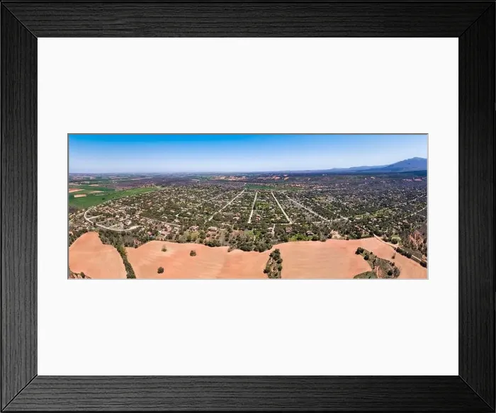 Framed Print : Panoramic aerial view of a large urbanization of country houses next to the mountain Framed Print : Panoramic aerial view of a large urbanization of country houses next to the mountain
