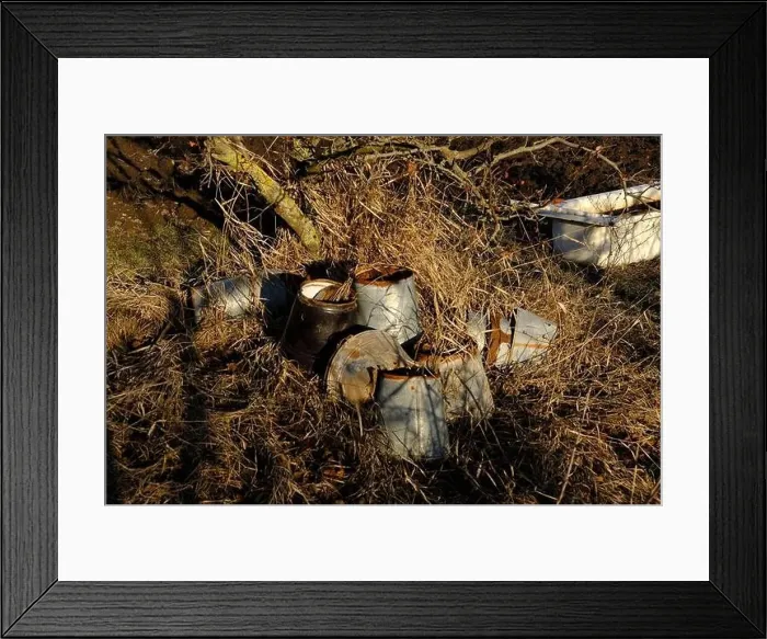 Framed Print : Old rusted damaged buckets in the village. Natural background of field with dry grass and fooliage Framed Print : Old rusted damaged buckets in the village. Natural background of field with dry grass and fooliage