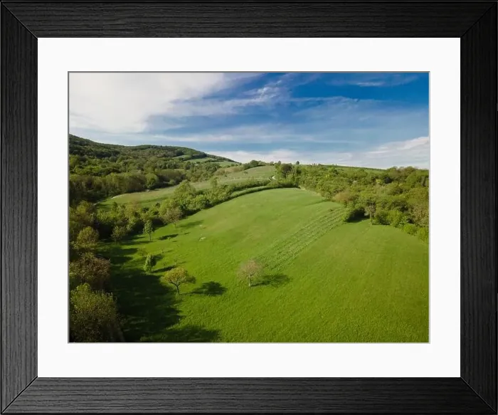 Framed Print : aerial drone flight over green meadows and forest in lower austria Framed Print : aerial drone flight over green meadows and forest in lower austria