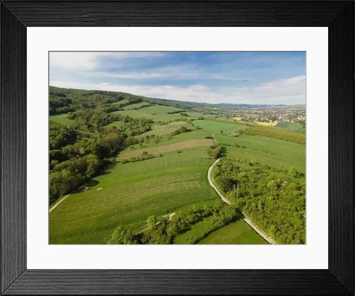 Framed Print : aerial drone flight over green meadows and forest in lower austria Framed Print : aerial drone flight over green meadows and forest in lower austria