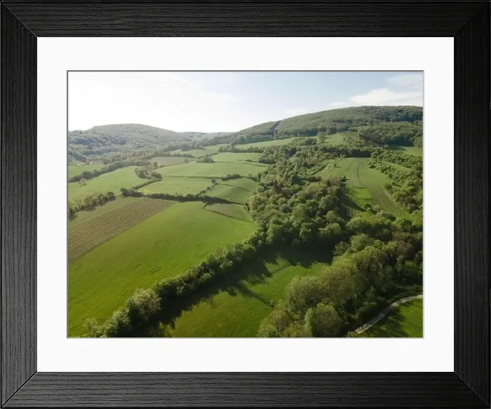 Framed Print : aerial drone flight over green meadows and forest in lower austria Framed Print : aerial drone flight over green meadows and forest in lower austria