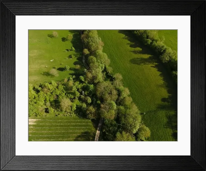 Framed Print : aerial drone flight over green meadows and forest in lower austria Framed Print : aerial drone flight over green meadows and forest in lower austria